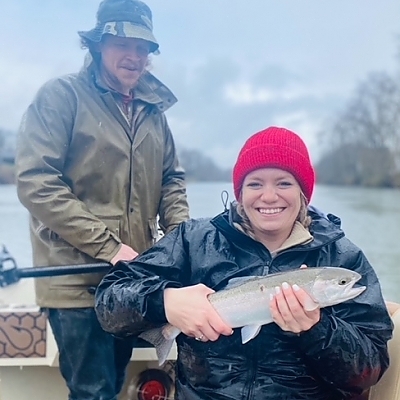 Older couple hold up fish caught on cold day.