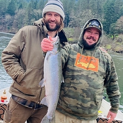 Two fishermen hold up their catch