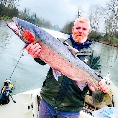 Holding up huge fish caught on OR trip.