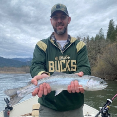 Man holding up fish on boat