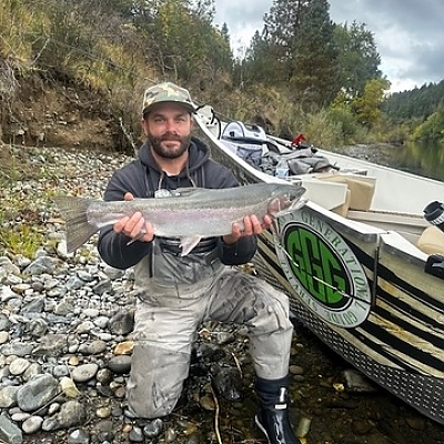  Man holding up fish caught alongside boat