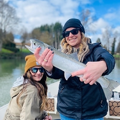 Two women holding up their catch