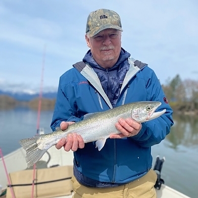 Older gentleman holds up huge fish