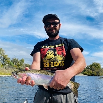 Man aboard boat holds up a huge fish